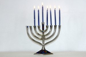 Families celebrate by lighting candles on a menorah throughout Hanukkah.