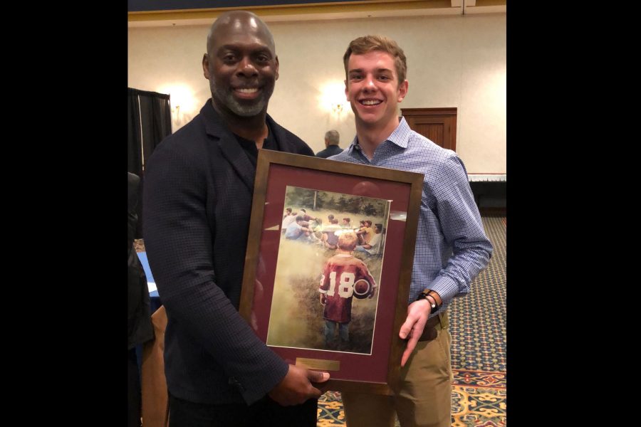 Los Angeles Chargers head coach Anthony Lynn congratulates senior Lawton Rikel at the FCA banquet on Rikels FCA Male Athlete of the Year award.