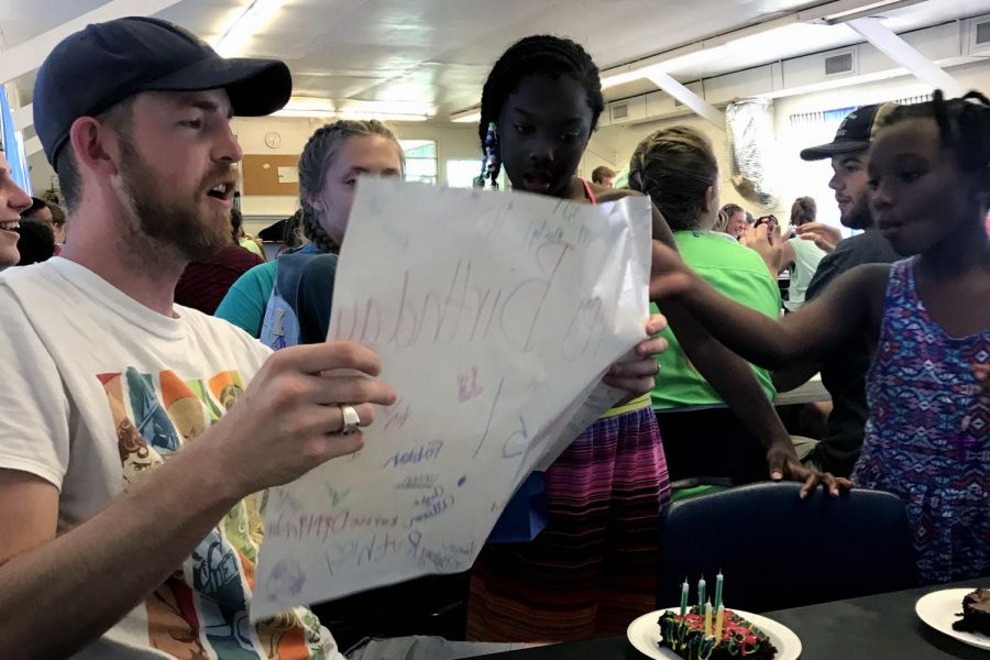 Roberts reads a birthday card students made him during Opportunity Camp, a mission project completed by the University Church of Christ youth group each year.