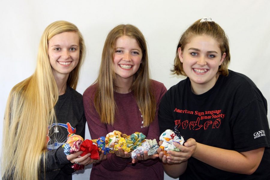Senior Macy McClish and juniors Emma Wilcox and Kodi Hicks display scrunchies made by McClish.