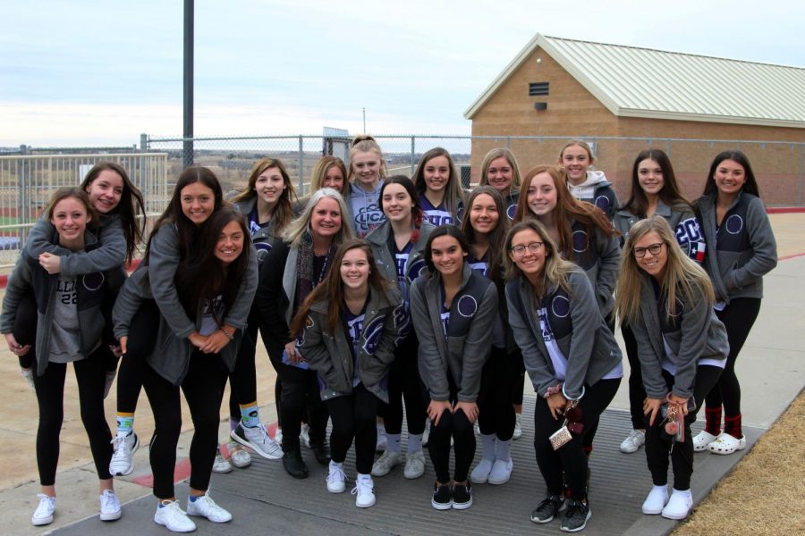 Principal Jennifer Boren accompanies the varsity cheerleaders before the team leaves for state competition following a school-wide send-off.