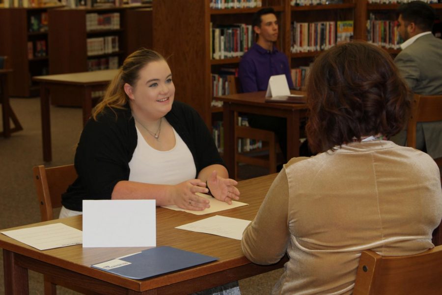 Senior Harley Tidwell interviews with a community member during Interview Week.