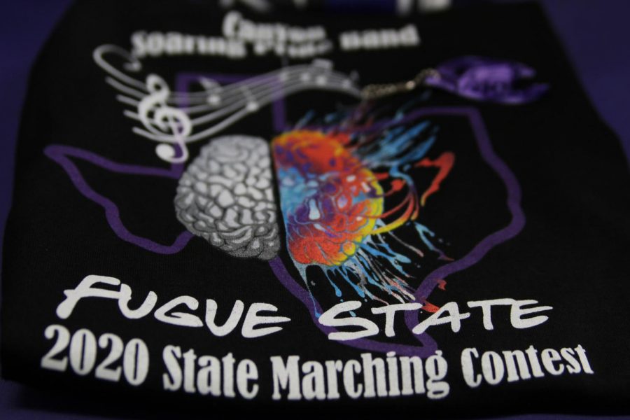 In preparation for State, the Soaring Pride Band boosters provided T-shirts to all band members. The shirt includes themes from the show as design elements.