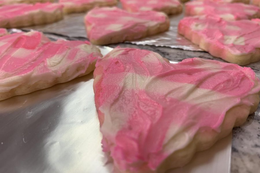 These+holiday+cookies+were+covered+in+white+icing%2C+then+sprayed+with+pink+color+mist%2C+which+can+found+at+Walmart%2C+while+using+a+stencil+to+create+the+checkered+pattern+for+Valentines+Day.%0A%0A