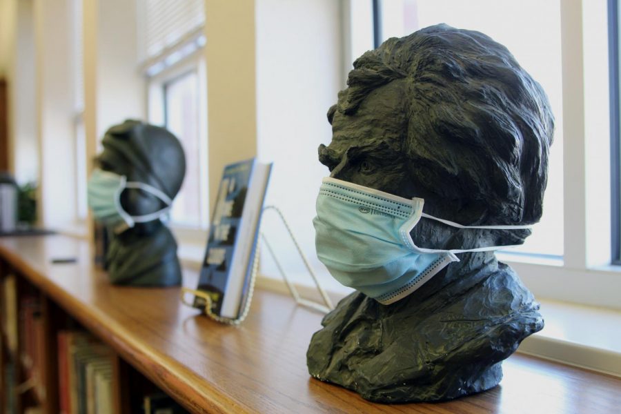 Sitting atop a shelf of library books in the nonfiction section of the learning commons, a statue head is adorned with a paper face mask. According to the Centers for Disease Control and Prevention, those over the age of two should wear a face mask while in a public setting or around people who do not live with the person. However, masks are not a substitution for social distancing. Staying six feet apart from others while indoors is advised. The CDC actively studies face masks and the effectiveness of mask variants and continually updates the public on their website, cdc.gov/coronavirus.
