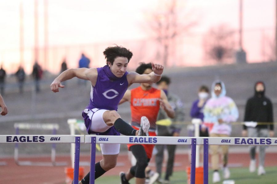 Sophomore Seth Green runs the 300 meter hurdle. “20% of the time we all mess around and joke with one another,” Green said. “The rest of the time we are really focused and work our hardest on becoming the best we can be. Hurdles are all about form and practice.”
