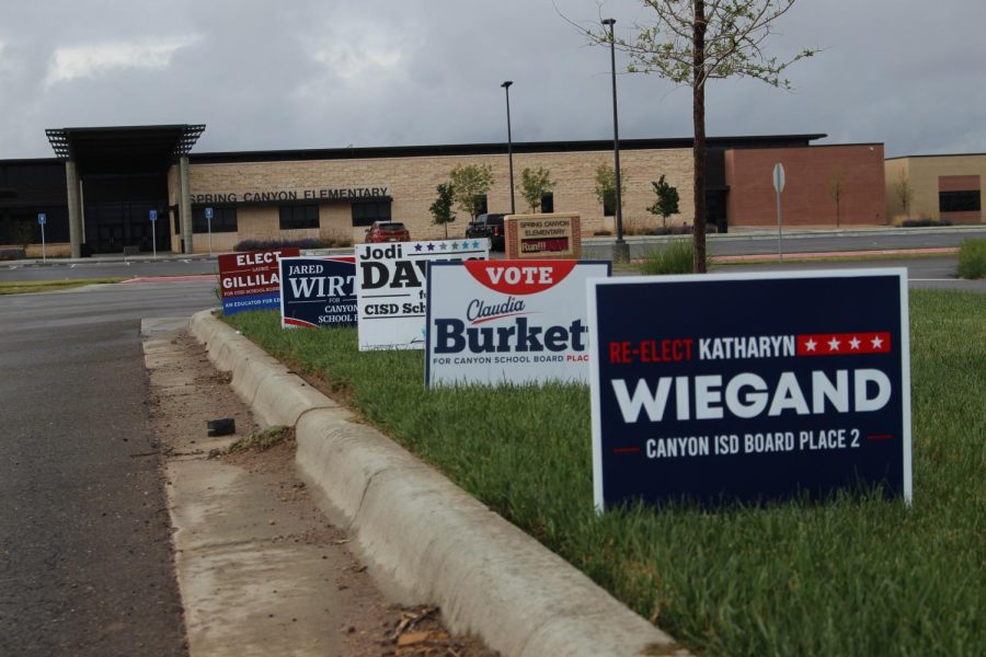 Street signs line the street leading up to Spring Canyon Elementary. Early voting began Monday and community members can vote all the way through May 6th.