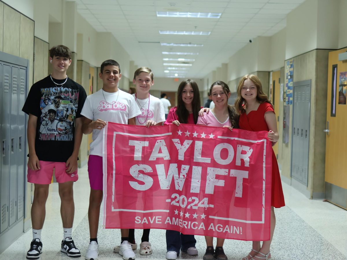 Freshman McKenzi Sechrist brings a pink Taylor Swift flag for the Barbie dress up day. Sechrist said at Canyon Junior High they are not allowed to wear flags, so this was her first opportunity to be able to do it. “Its Hoco week and you wanna support your school, and be a part of a community where we get to have that,” Sechrist said. “Some schools dont do that, they just have the Homecoming game and thats it. Being able to dress up and have fun with the people in my class is nice.