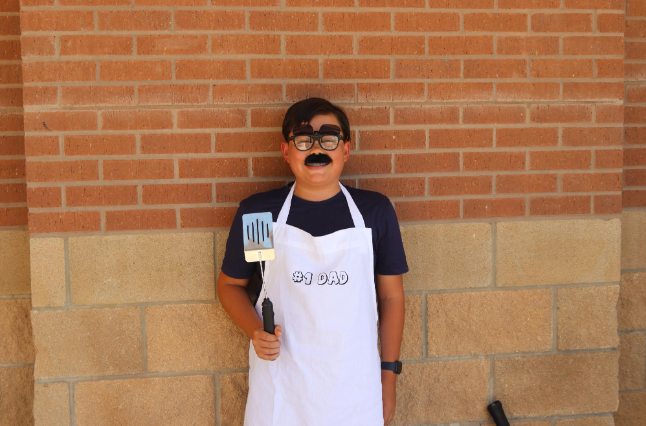 Freshman Kyler Little participates in the Soccer Mom vs. BBQ Dad dress up day. Little dressed as a BBQ dad with a mustache and a clip on sunglasses. I thought it was fun and creative, Little said. I wore it to give people a laugh.