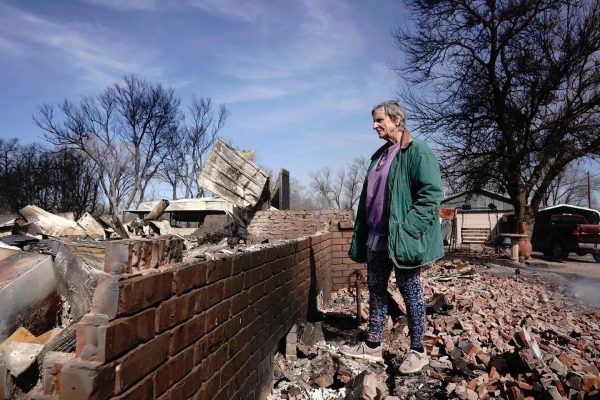 A woman searches through the remains of her house after the Smokehouse Creek Fire burned through Canadian, TX on Tuesday Feb. 27, 2024.