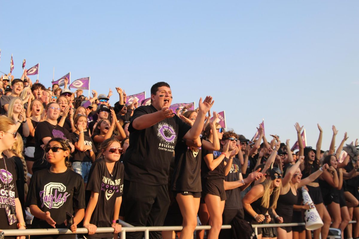 Junior Reegan Garcia cheers at Boss Bowl game. "When I helped out the family at Texas Rose, I remember my family was there for me, so if I can be there for them then that's the way to go."