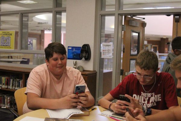 Wyatt Rockholt and Treyson Ward are on their phones in the library. "The new phone enforcement should be removed all together," Rockholt said. "It isn't doing anything to benefit us anyways."