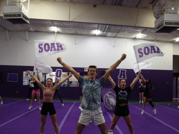 Junior Kelton Klumb practices during cheer practice. "I just try to be myself, and then it's pretty easy, it's pretty fun.” Klumb said.  