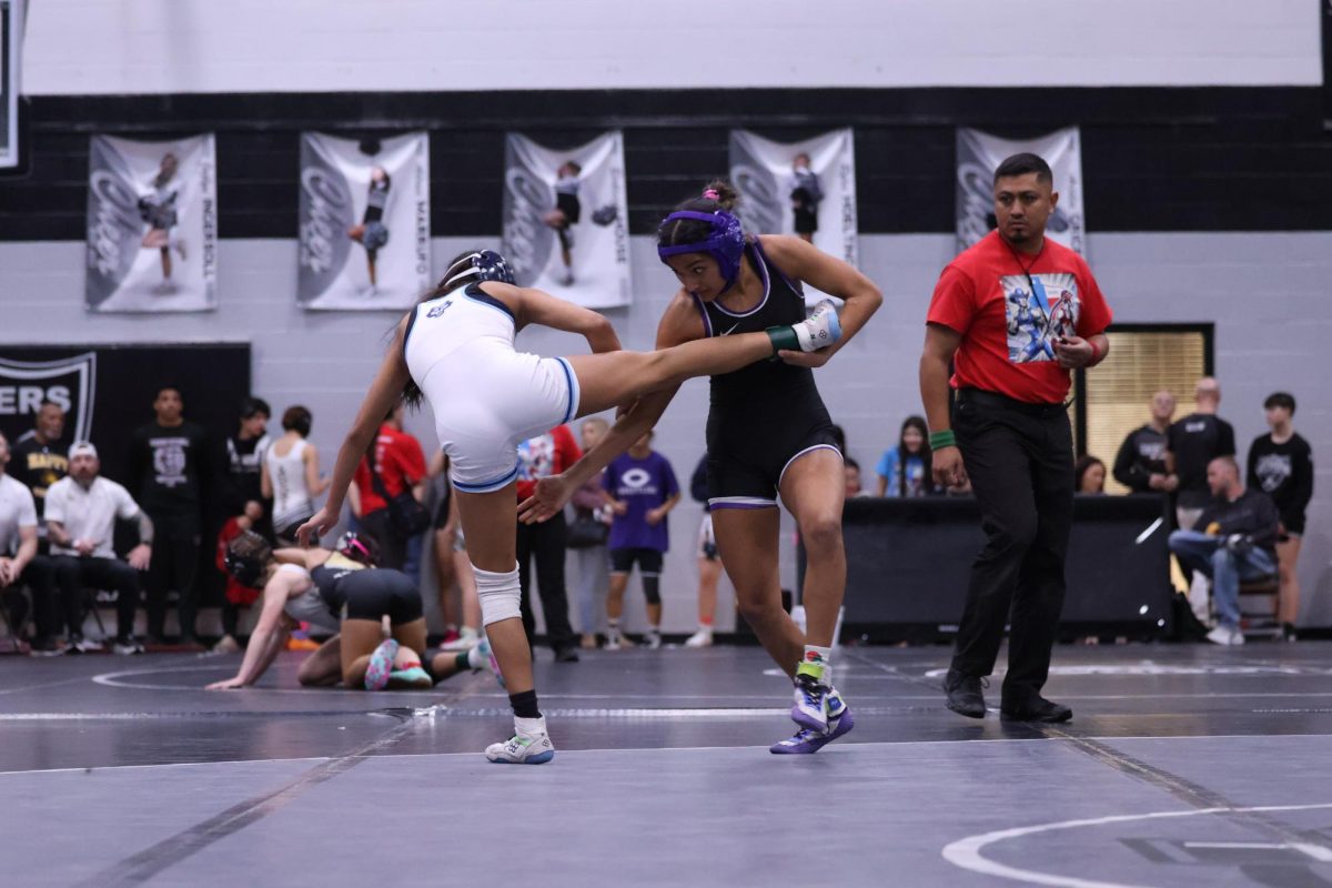 Senior Alizae Reveles wrestles her opponent. 