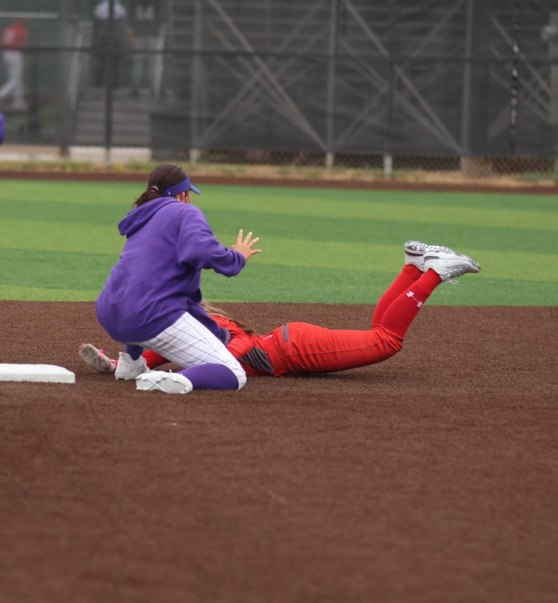 Junior, second baseman, Bayleigh Burks goes for the tag at second against the Perryton Rangers.