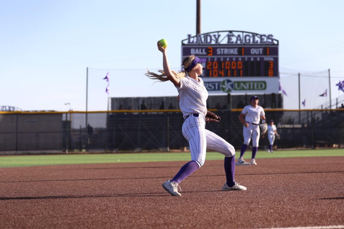 Junior, short stop, Addison Ralston throws to first to gain an out.