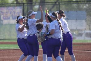 2025 Softball starting lineup celebrates a strike-out.