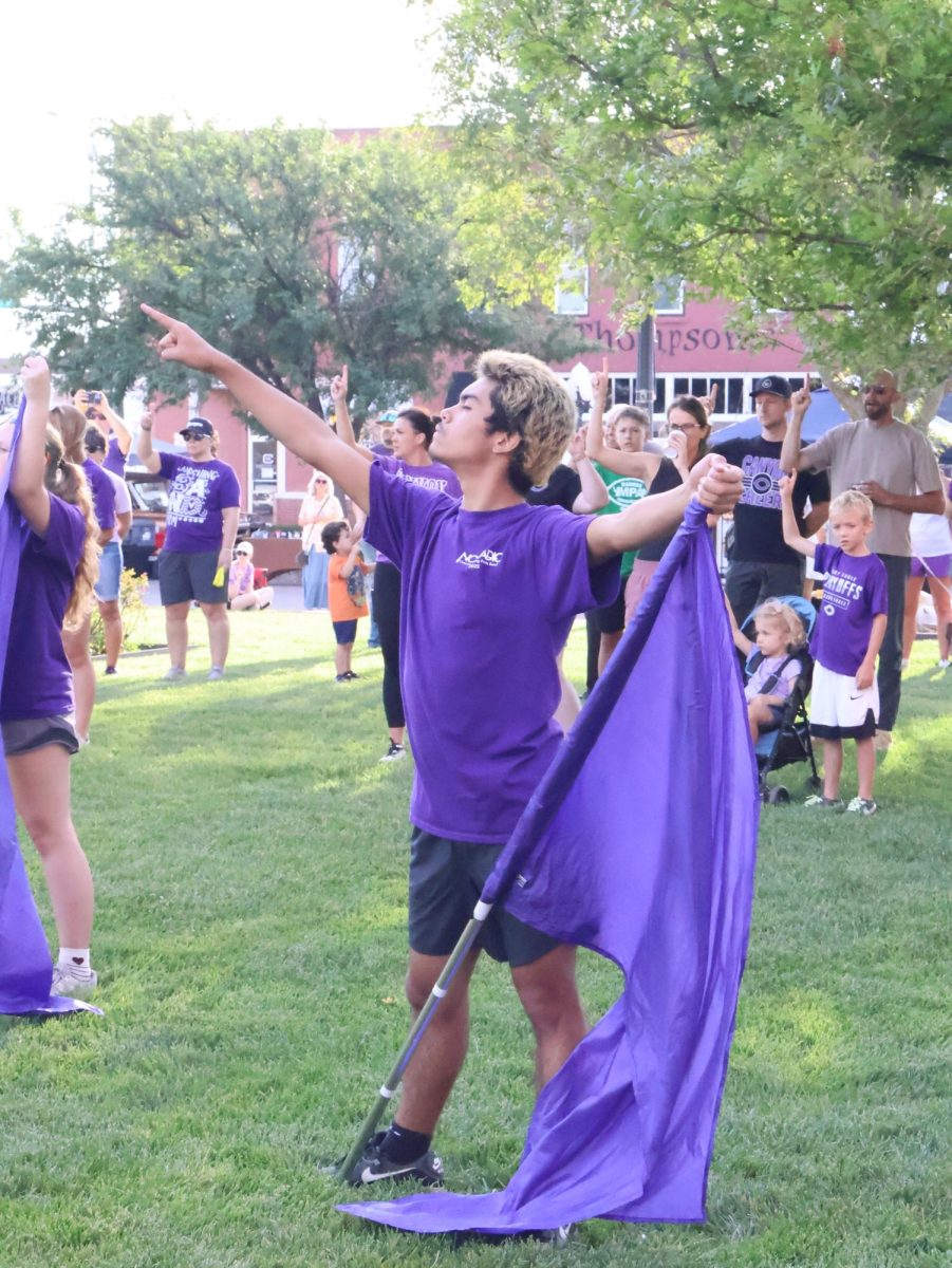 Aiden Carrillo (11) completing a color guard routine. 