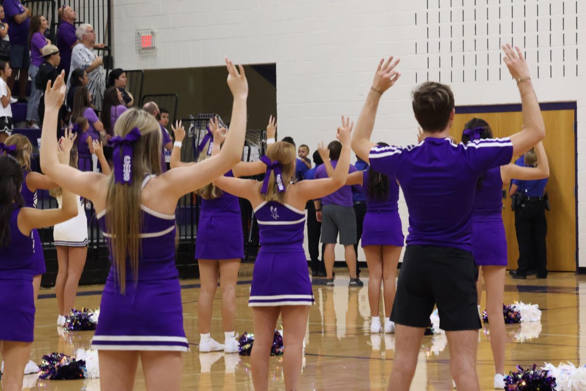 Cheer team signing the national anthem.