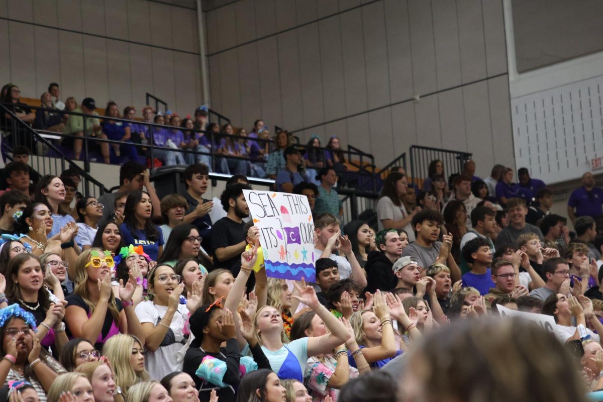 Juniors holding up a sign in competition.