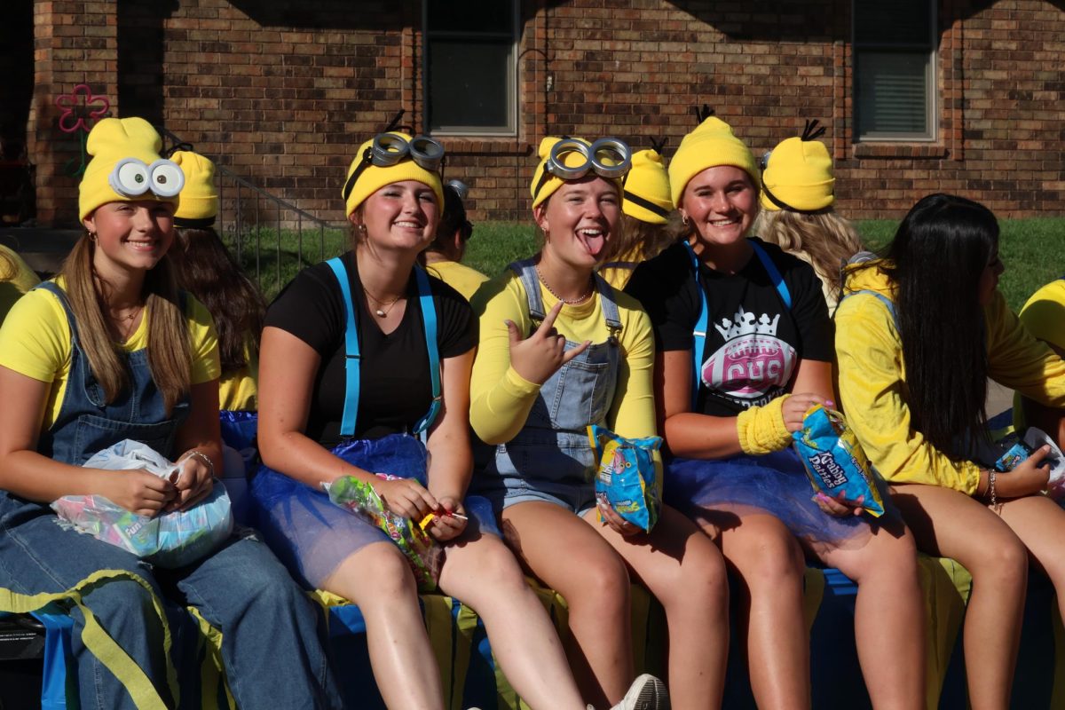 Softball players Hailey Spinks (9), Ellie Mitchell (9),  Shyanne Blackerby (10), and Kate Knox (10) ride on the softball homecoming parade.