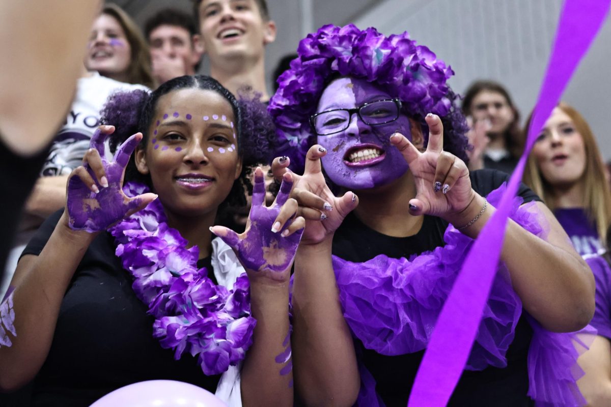 Emery Crowder (12) and Kinzie Washington (12) are decked out in purple for the pep rally.